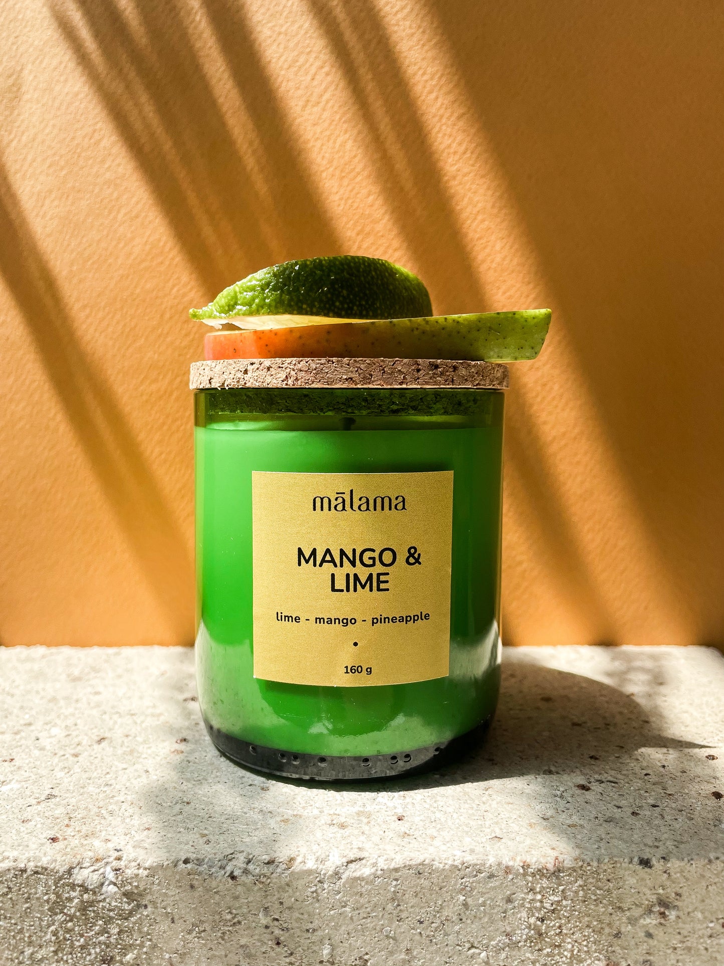 "Mango & Lime": yellow label, topped with a lime wedge.