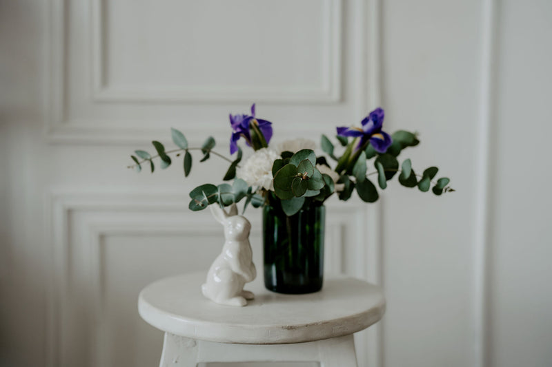 a beautiful flower bouquet in a vase made from upcycled wine bottle